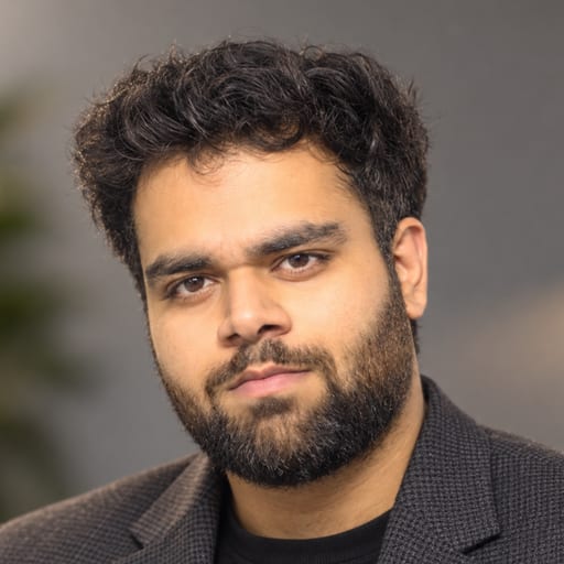 Portrait of Anshul Paliwal in a dark blazer